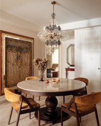 A console custom made by Beyond Dreams peeks from one corner of the dining room, with a mirror above it from Beyond Designs; Photography by Rohit Mendiratta