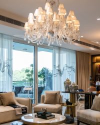 The apartment’s nucleus borders green vistas that lie beyond. Conversations and gatherings float between the living, dining, and deck uninterruptedly; Photography by Vaibhav Bhatia