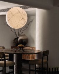 Crafted in African marble, the dining table is rooted under the sculptural luminaire by Davide Groppi. The dining chairs are bespoke creations by Yashesh Virkar; Photography by Ishita Sitwala