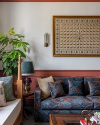 The formal living area mirrors the essence of the home: maximal, yet rooted in culturist essence and warmth. The 3-seater Sofa from Gulmohar Lane was later reupholstered with fabric from Cottons & Satins, the coffee table is from Magnolia Home, and the day bed was done by a carpenter on site; Photography by Kuber Shah
