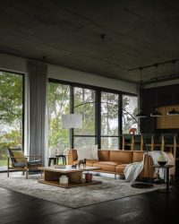Black marble flooring grounds the space, paired with a customised leather sofa and centre table, a rug and a floor lamp