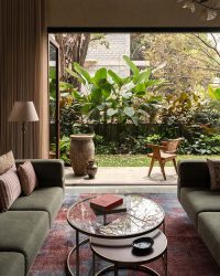 Relishing inside-outside living, the gathering space performs as the home’s nucleus. The red of the Jaipur Rugs carpet and green’s omnipresence paint a grounding scene; Styled by Studio 4A, Photography by Syam Sreesylam